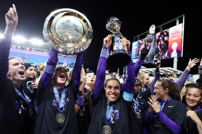 Orlando Pride players celebrate after defeating the Washington Spirit 1-0 in the NWSL 2024 Championship Game at CPKC Stadium on November 23, 2024 in Kansas City, Missouri.