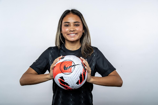 Former Angel City FC forward Alyssa Thompson poses with a soccer ball.