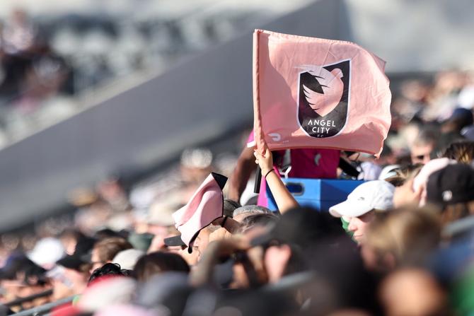 A fan waves an Angel City FC flag during a game between Angel City FC and Bay FC at BMO Stadium on March 17, 2024 in Los Angeles, California.