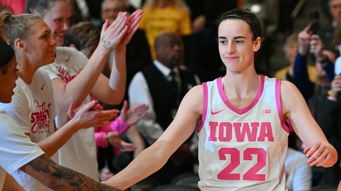 Iowa Hawkeyes guard Caitlin Clark high fiving her teammates