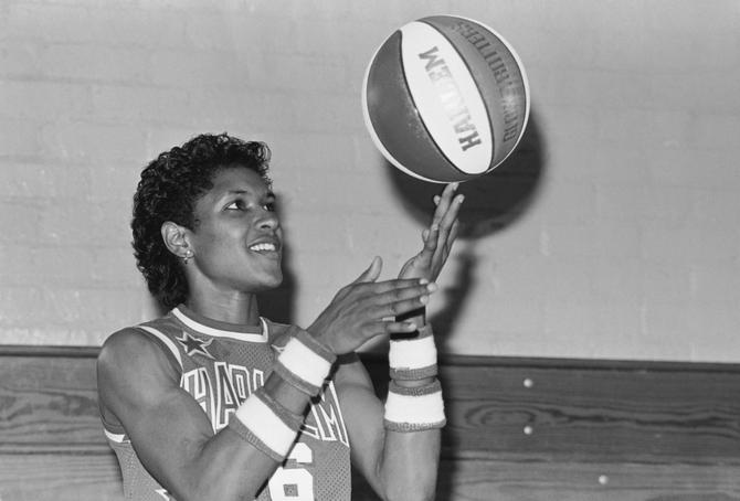 Harlem Globetrotter Lynette Woodard spins a ball on her finger.
