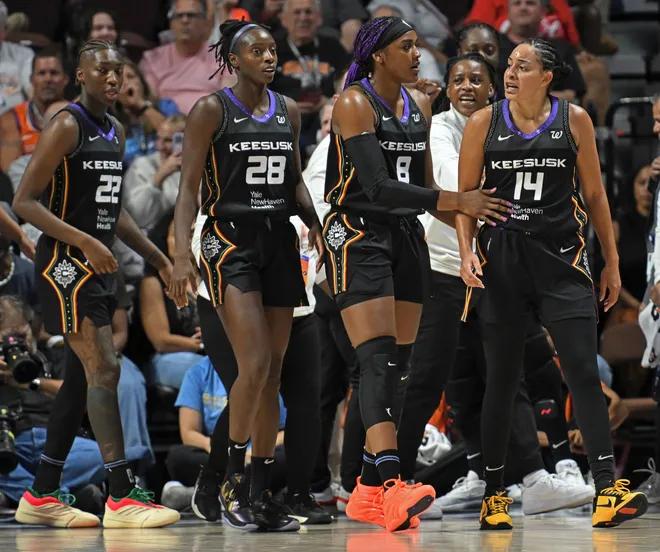Connecticut Sun player Bria Hartley’s teammates attempt to calm her down after a scuffle.
