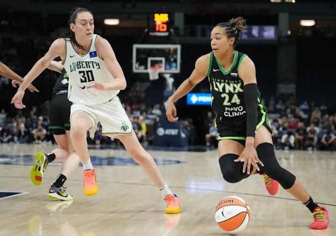 The Minnesota Lynx’ Napheesa Collier drives against NY Liberty’s Breanna Stewart