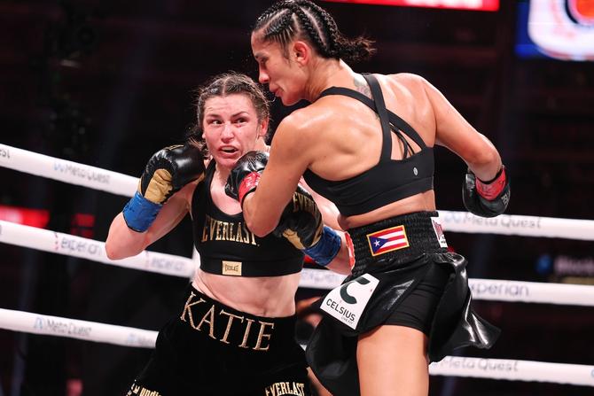 Katie Taylor and Amanda Serrano fighting in a boxing ring