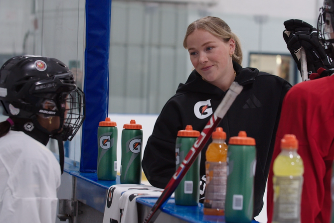 Sarah Fillier talking to her fellow hockey players