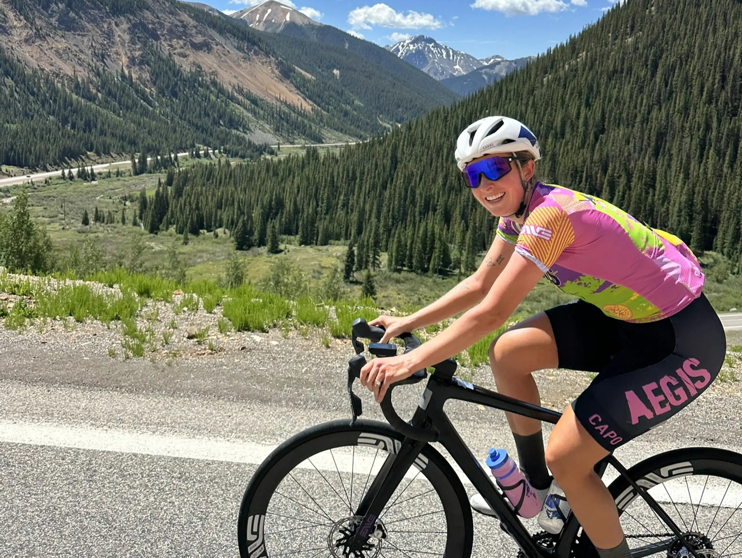 Laini Bones rides a mountain pass.