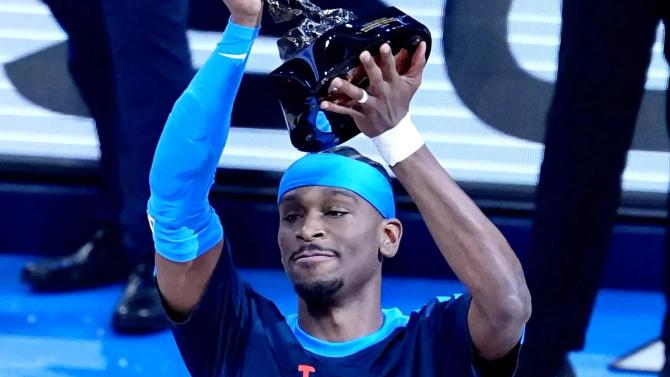 Shai Gilgeous-Alexander raising the MVP trophy