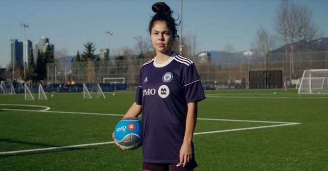 Jeneva Hernandez Gray posing with a soccer ball