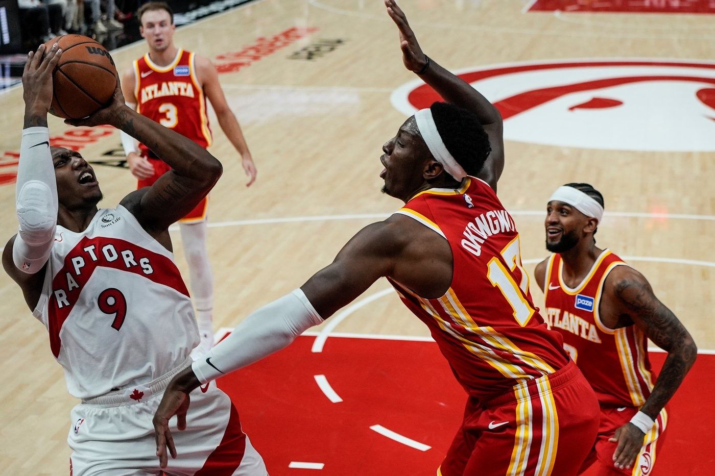 Toronto Raptor R.J. Barrett shoots the ball over an Atlanta Hawks defender in the team’s season opener.
