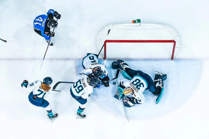 Corinne Schroeder makes a save while three of her teammates work to clear the puck against Toronto on Jan. 1. The photo is taken from above.