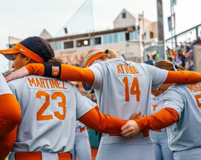 Members of the No. 5 Texas softball team huddle up.