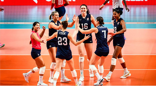 USA Volleyball players congratulate each other on the court.