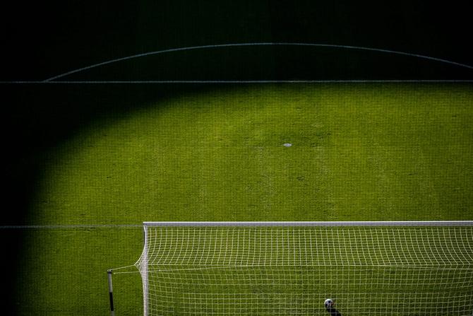 A soccer field with a ball in the goal