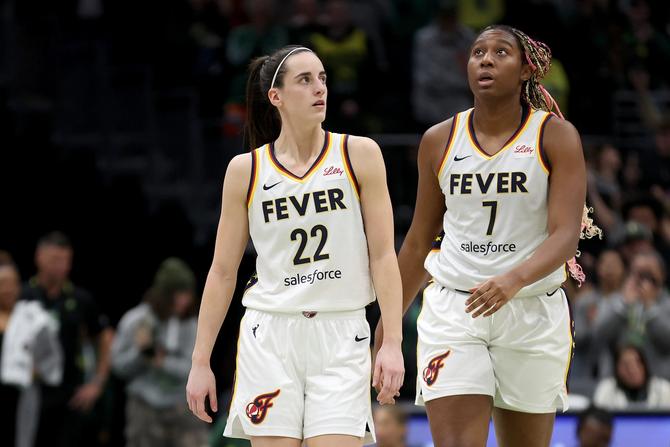 Caitlin Clark #22 and Aliyah Boston #7 of the Indiana Fever react after losing to the Seattle Storm at Climate Pledge Arena