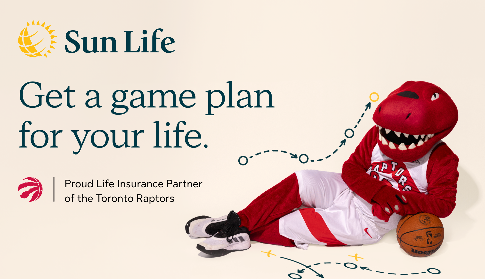The Toronto Raptors mascot lying on the ground with a basketball