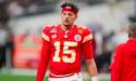 Kansas City Chiefs quarterback Patrick Mahomes looks on from the sidelines.