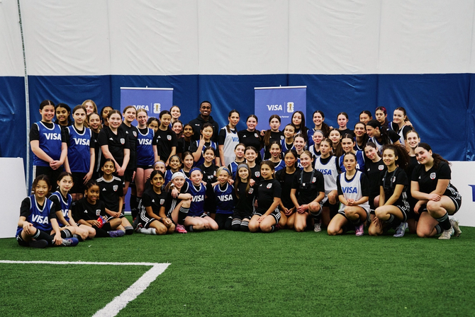A group photo of young soccer players and their mentors