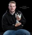 Buffalo Bills kicker Tyler Bass cradles a kitten.