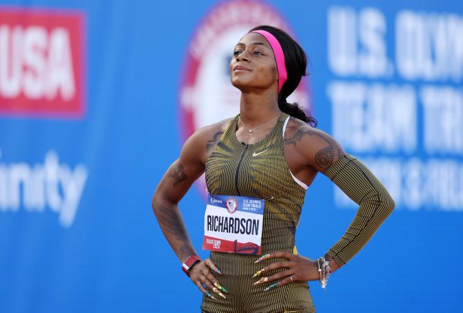 Sha’Carri Richardson stands with her hands on her hips.