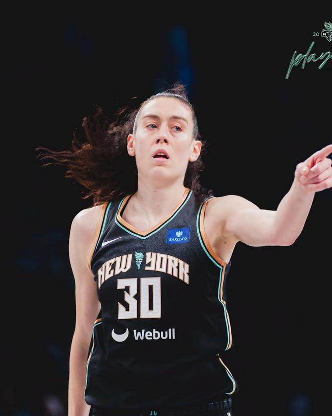 New York Liberty star Breanna Stewart celebrates on the court.