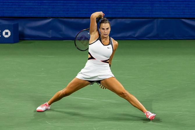 Aryna Sabalenka slides on the court of the US Open.