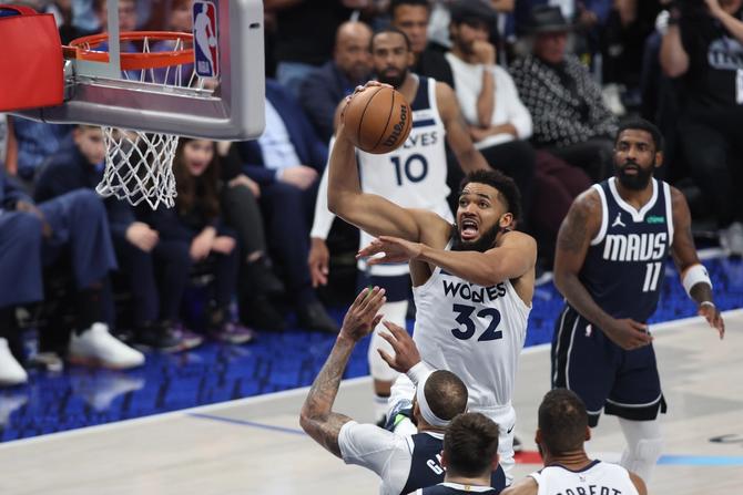Karl-Anthony Towns #32 of the Minnesota Timberwolves drives to the basket against the Dallas Mavericks during the fourth quarter in Game Four of the Western Conference Finals.