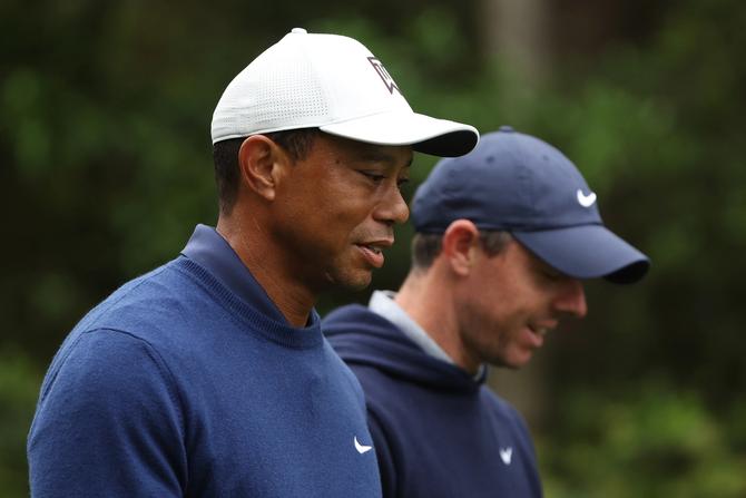 Tiger Woods of the United States and Rory McIlroy of Northern Ireland walk to the 11th fairway during a practice round prior to the 2023 Masters Tournament at Augusta National Golf Club on April 03, 2023 in Augusta, Georgia.