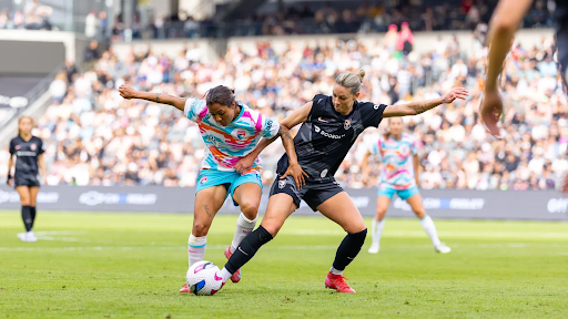 Players compete for the ball during a matchup between Angel City FC and the San Diego Wave.