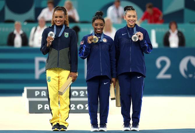 Simone Biles, Rebecca Andrade and Suni Lee pose with their medals