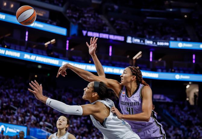 The Golden State Valkyries’ Kiah Stokes battles for a rebound against Las Vegas Ace A’ja Wilson.