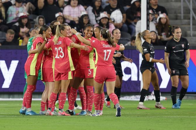 Portland Thorns FC teammates celebrate after a goal.