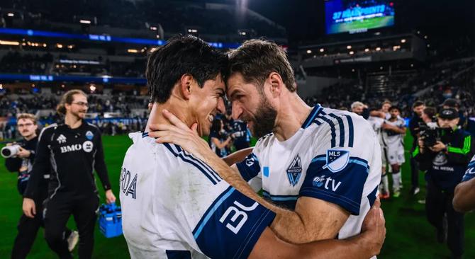 Two Vancouver Whitecaps players embrace after their semifinal win.
