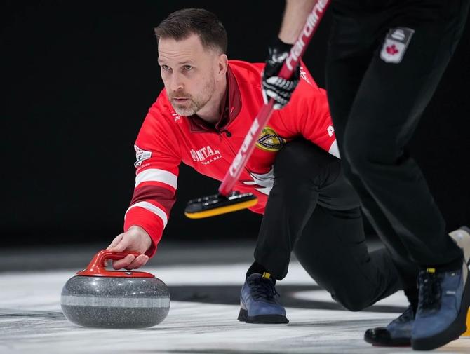 Brad Gushue of Team Gushue throws a stone.