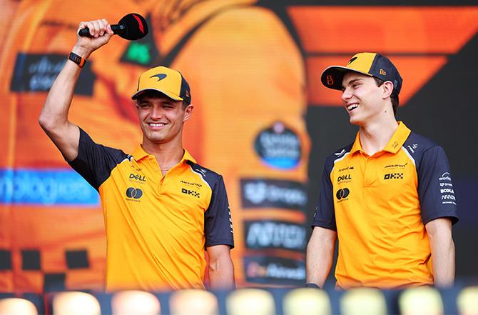 Lando Norris and Oscar Piastri smiling on stage