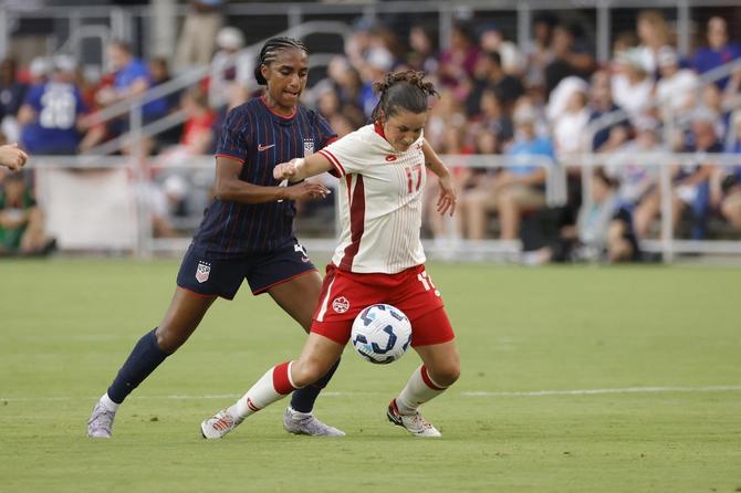 USWNT’s Naomi Girma goes up against CanWNT’s Jessie Fleming.