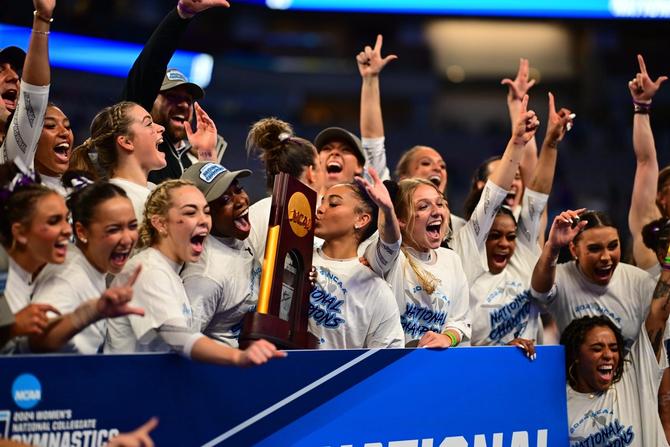 The No. 2–seed LSU women’s gymnastics team celebrates with their trophy after winning Saturday’s national championship.