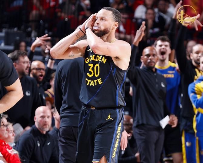 Golden State Warriors superstar Steph Curry does his signature celebration after hitting a clutch three, putting his hands under his head like he’s sleeping.