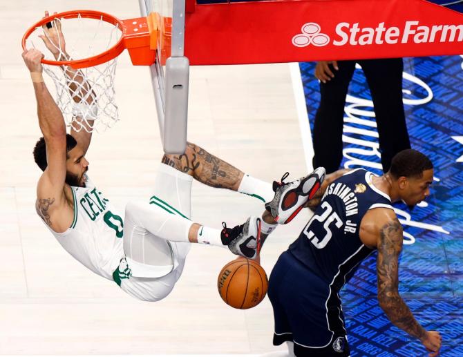 Boston Celtics forward Jayson Tatum dunks over Dallas Mavericks forward P.J. Washington.