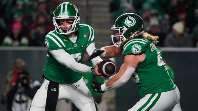 Saskatchewan Roughriders quarterback Trevor Harris hands off the ball to running back A.J. Ouellette.
