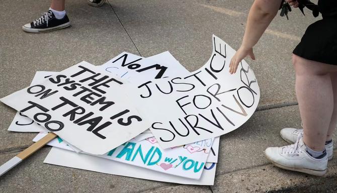 Signs supporting E.M. lay on the ground.