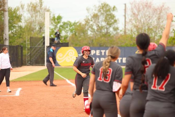 Aly Kaneshiro rounding the bases to meet her teammates at home plate