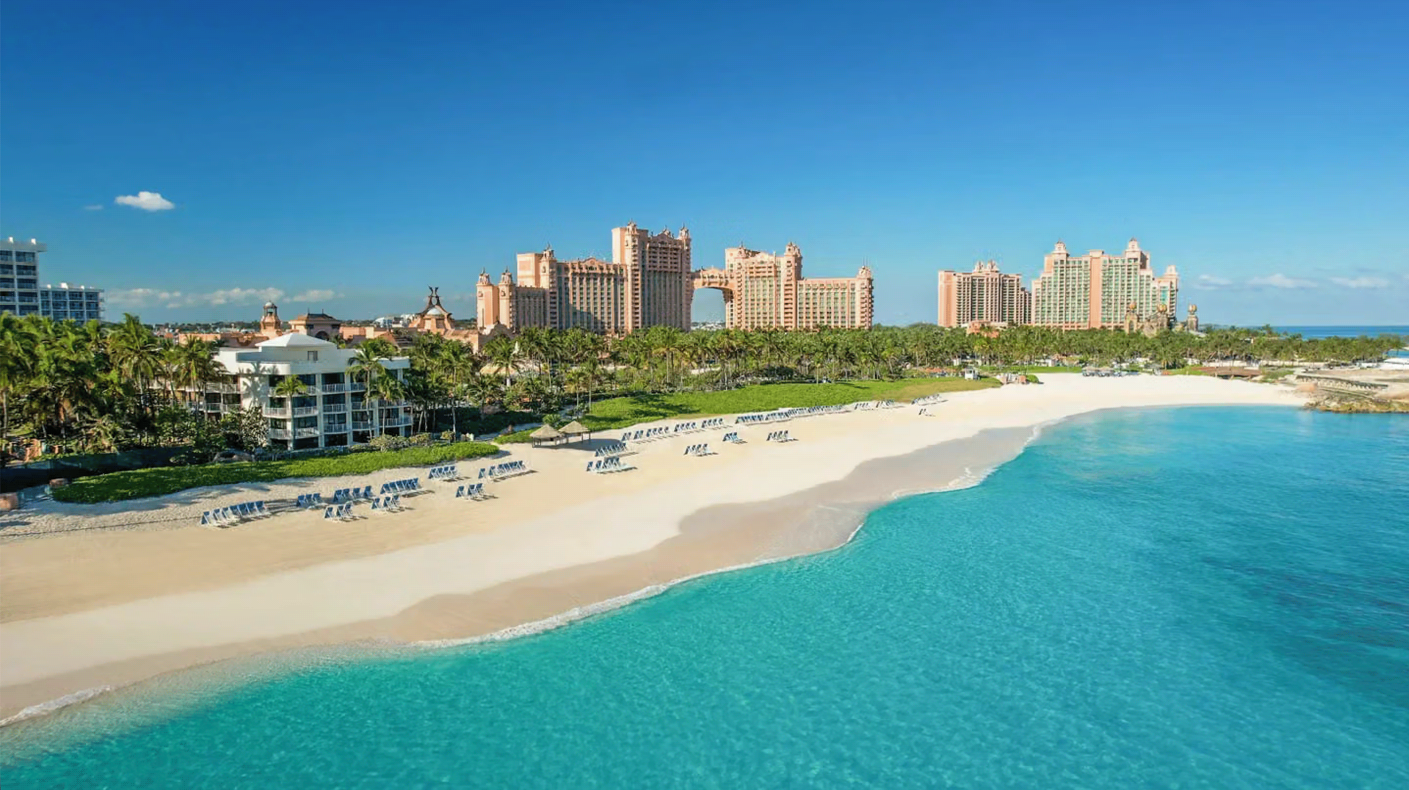 Aerial view of Atlantis Resort, surrounded by bright blue ocean and sand.