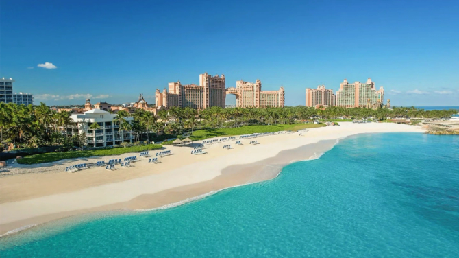 Aerial view of Atlantis Resort, surrounded by bright blue ocean and sand.