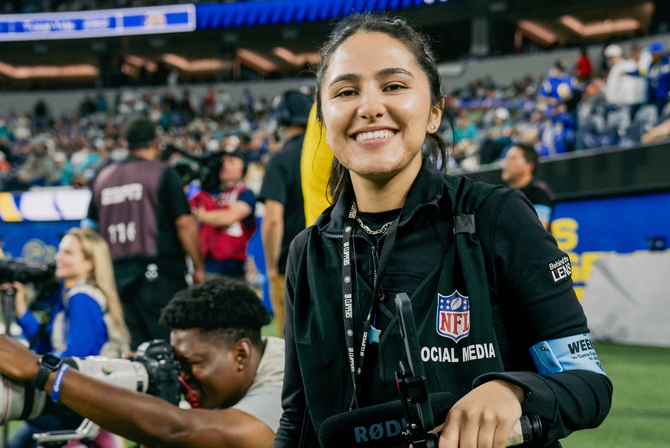 Sujey smiling at the camera on the football field