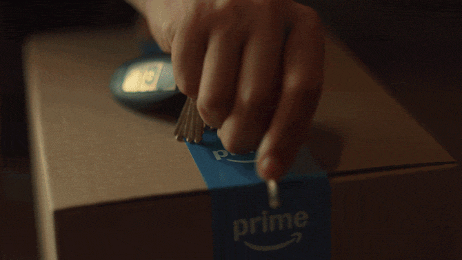 A man opens an Amazon box containing an string of lights for his truck bed, text reads "Date Night. Same-Day Delivery. It's on Prime"