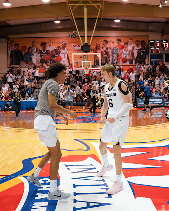 Colorado men’s basketball players celebrate after their upset win over No. 2 UConn
