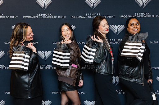 Women pose with Sephora gift bags at an event promoting the beauty retailer’s talent incubator.