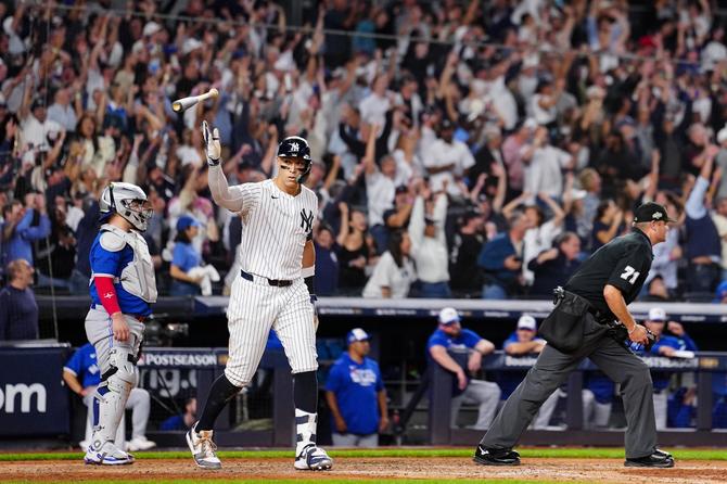 Aaron Judge #99 of the New York Yankees reacts after hitting a game-tying three-run home run in the fourth inning of Game Three of the American League Division Series