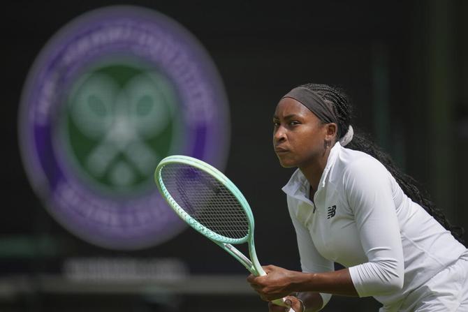 Coco Gauff eyes the camera while practicing at Wimbledon.