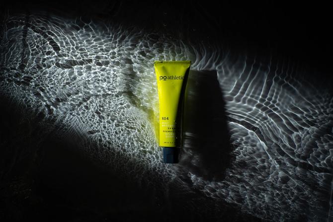 A yellow tube of Po Athletic Skincare floating on water